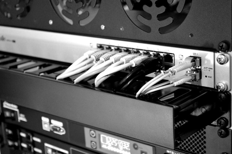 Network switch with bundled data cables connected, representing fiber-optic internet