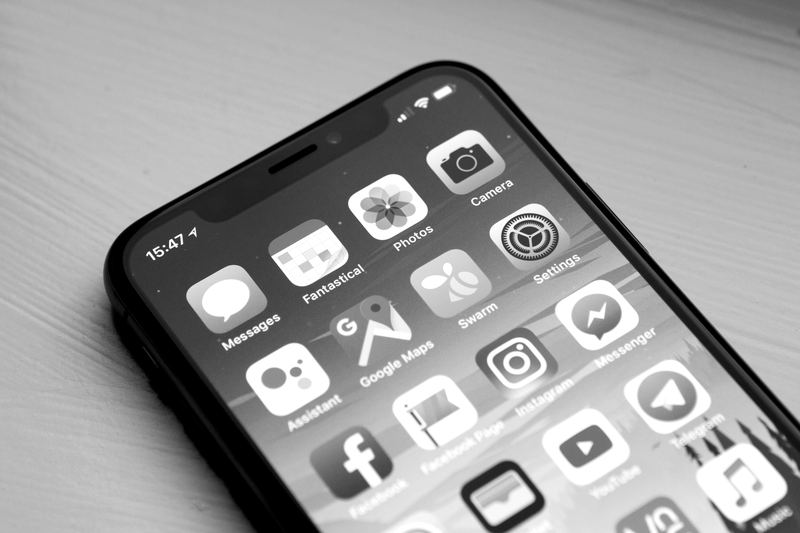 Smartphone home screen showing apps, representing wireless phones and plans
